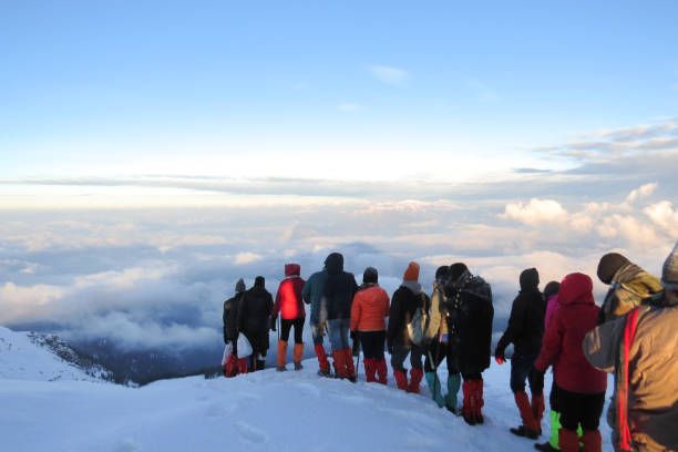 A group of trekkers on a descend from the summit of a mountain
